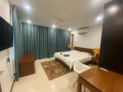 a bedroom with a bed and a desk and a television at Seaview Prima Villa Karon beach in Karon Beach
