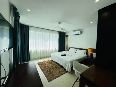 a hotel room with a bed and a television at Seaview Prima Villa Karon beach in Karon Beach