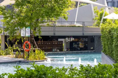 a building with a fountain in the water in front of it at VARANA Krabi Hotel in Klong Muang Beach