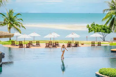 a woman standing in the water in a pool at a resort at Anantara Koh Yao Yai Resort & Villas in Ko Yao Yai