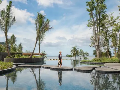 a statue of a woman standing in a pool at a resort at Anantara Koh Yao Yai Resort & Villas in Ko Yao Yai
