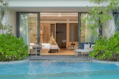 a hotel room with a bed and a swimming pool at Anantara Koh Yao Yai Resort & Villas in Ko Yao Yai