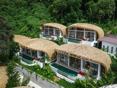 an aerial view of a house with thatched roofs at Three Monkeys Villas in Patong Beach