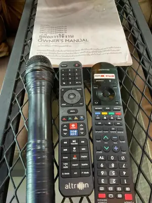 a remote control and a microphone in a basket at Sea Smile Green View Pool Villa KRABI Klong Muang in Klong Muang Beach