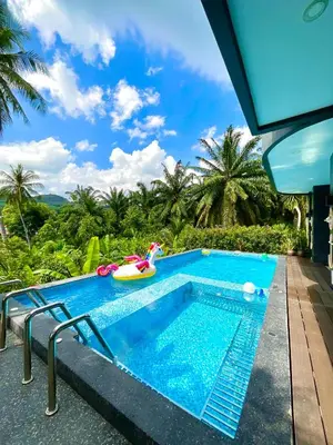 a swimming pool at a resort with a pool slide at Sea Smile Green View Pool Villa KRABI Klong Muang in Klong Muang Beach