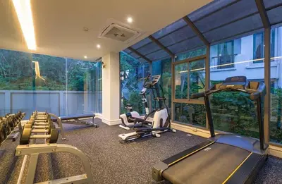 a gym with treadmills and ellipticals in a room with windows at CORNER SEA VIEW KRABI Ao Nang 4 STARS HOTEL RESIDENCE in Ao Nang Beach