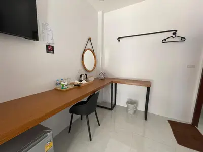 a room with a desk with a mirror and a chair at PP. Valentine Bungalow in Phi Phi Don