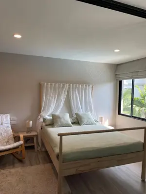 a bedroom with a large bed with a window at Nai Yang Beach Holiday Rental Apartement - Title Residence in Nai Yang Beach