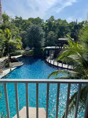 a view of a swimming pool from a balcony at Nai Yang Beach Holiday Rental Apartement - Title Residence in Nai Yang Beach