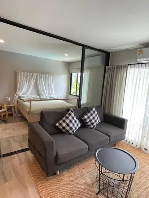 a living room with a couch and a bed at Nai Yang Beach Holiday Rental Apartement - Title Residence in Nai Yang Beach