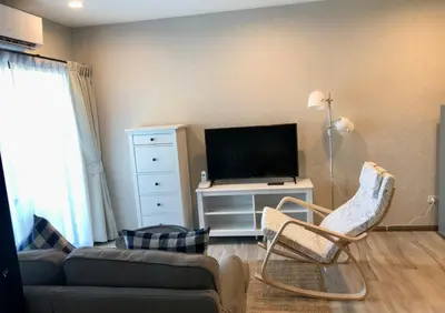 a living room with a couch and a tv at Nai Yang Beach Holiday Rental Apartement - Title Residence in Nai Yang Beach