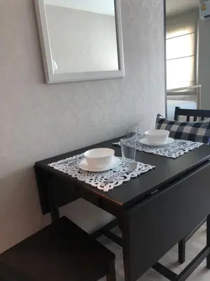 a table with two bowls and plates on it at Nai Yang Beach Holiday Rental Apartement - Title Residence in Nai Yang Beach