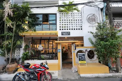 a store with a motorcycle parked in front of it at Auntie & Niece PHUKET in Ban Sam Kong