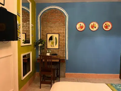 a room with a table and plates on the wall at Auntie & Niece PHUKET in Ban Sam Kong