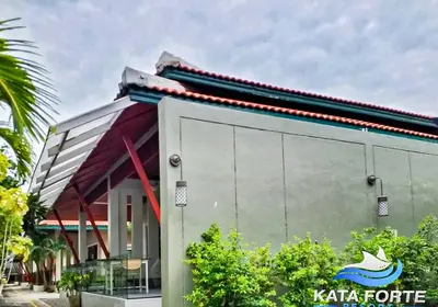 a building with a sign on the side of it at Kata Forte Resort in Kata Beach