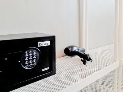 a microwave sitting on a shelf next to a faucet at Kata Forte Resort in Kata Beach