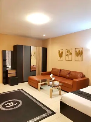 a living room with a couch and a table at The Luka Guesthouse in Patong Beach
