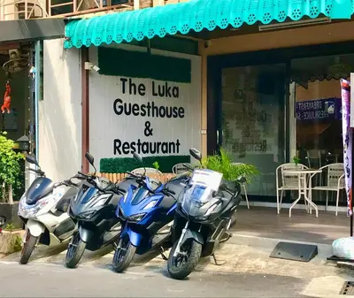 a group of motorcycles parked outside of a restaurant at The Luka Guesthouse in Patong Beach