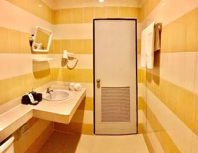 a bathroom with a sink and a shower at The Luka Guesthouse in Patong Beach