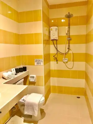 a bathroom with a shower and a toilet at The Luka Guesthouse in Patong Beach