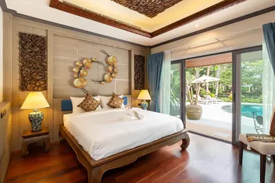 a bedroom with a large bed and a pool at Villa Carlos, Luxury 7 BDR Private Pool Villa, Baan Bua Nai Harn, Phuket in Rawai Beach