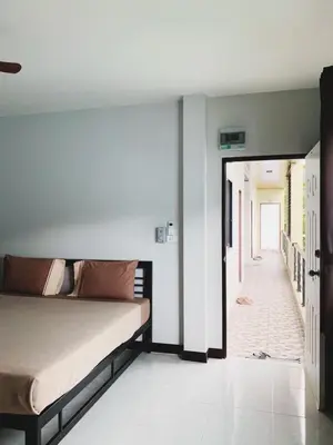 a bedroom with a bed and a hallway at Himma's Apartment in Kamala Beach