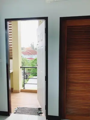 a door leading into a room with a balcony at Himma's Apartment in Kamala Beach