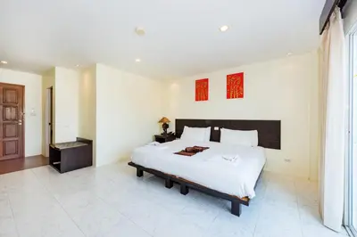 a bedroom with a large bed in a room at My Hotel Phuket in Patong Beach