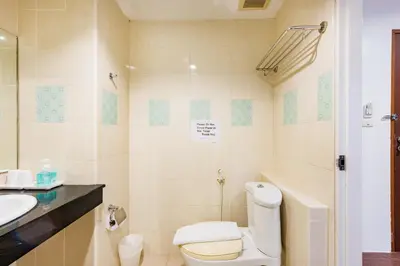 a bathroom with a toilet and a sink at My Hotel Phuket in Patong Beach