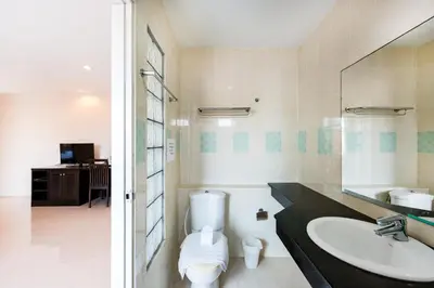 a bathroom with a sink and a toilet at My Hotel Phuket in Patong Beach
