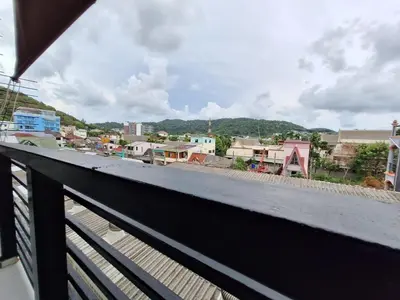 a view of a city from a balcony at Sea Boss Homestay in Kata Beach