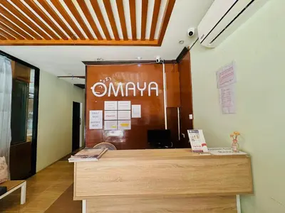 an office with a reception desk with a sign on the wall at Cocoon Omaya Guest House in Patong Beach