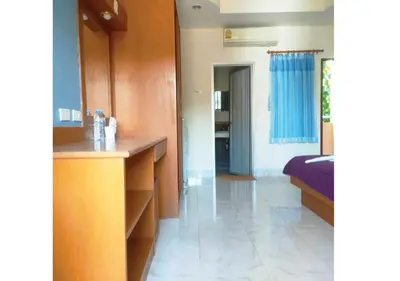 a room with a bed and a desk in it at Pailin Hill Hotel in Patong Beach