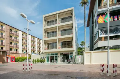 a tall building with a street light in front of it at Casa De Coral Boutique Hotel in Kata Beach