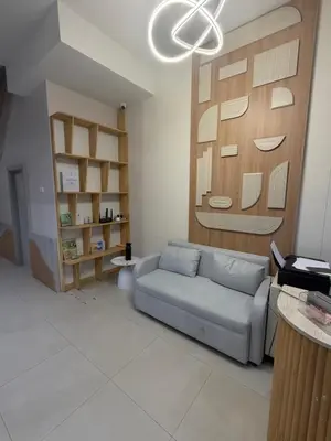 a living room with a couch and a wooden wall at Casa De Coral Boutique Hotel in Kata Beach