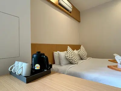 a hotel room with two beds and aperature at Casa De Coral Boutique Hotel in Kata Beach