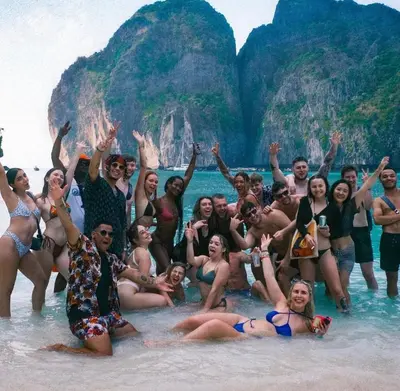 a group of people in the water at the beach at Bodega Koh Phi Phi in Phi Phi Don