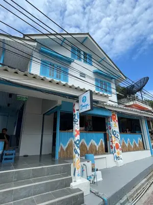 a blue building with a sign in front of it at Bodega Koh Phi Phi in Phi Phi Don