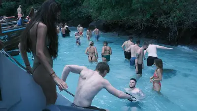 a group of people standing in the water at Bodega Koh Phi Phi in Phi Phi Don