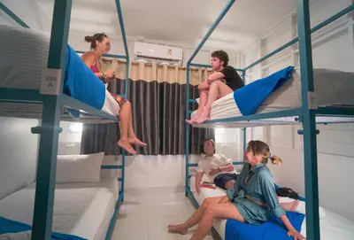 a group of people sitting on bunk beds at Bodega Koh Phi Phi in Phi Phi Don