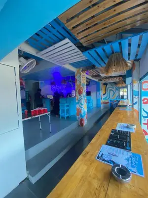 a long table in a room with blue ceilings at Bodega Koh Phi Phi in Phi Phi Don