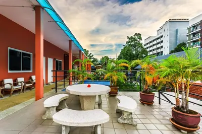 a patio with a table and benches on a balcony at Jungceylon Villa - quiet location, pool, maid in Patong Beach