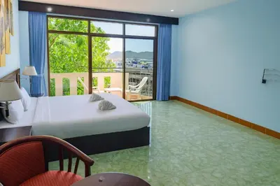a bedroom with a bed and a large window at Riviera Patong in Patong Beach