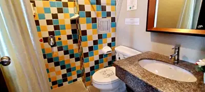 a bathroom with a toilet and a sink at Southern Comfort Patong in Patong Beach