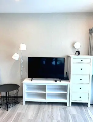 a living room with a tv and a white dresser at А2 ВАТСАП669З582I976 примем РУБЛИ in Nai Yang Beach