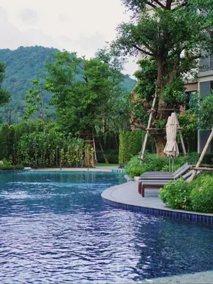 a pool at a resort with an umbrella and a bench at А2 ВАТСАП669З582I976 примем РУБЛИ in Nai Yang Beach