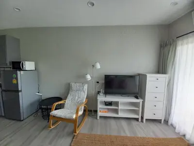 a living room with a television and a chair at В7 НОВАЯ КВАРТИРА ВАТСАП669З582I976 можно РУБЛЯМИ in Nai Yang Beach