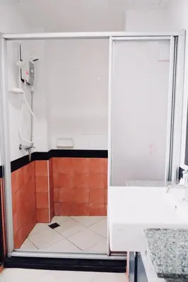 a shower with a glass door in a bathroom at Ratana Residence Thalang in Thalang