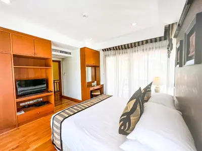 a bedroom with a large bed and a television at 3-4BR Laguna Phuket Golf Course Villa with Pool & Jacuzzi in Laguna Phuket