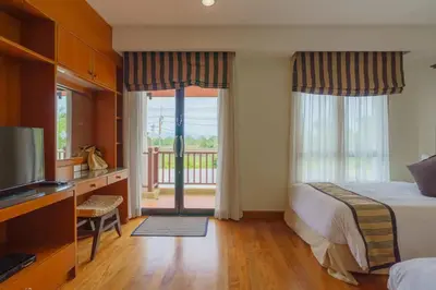 a hotel room with a bed and a sliding glass door at 3-4BR Laguna Phuket Golf Course Villa with Pool & Jacuzzi in Laguna Phuket